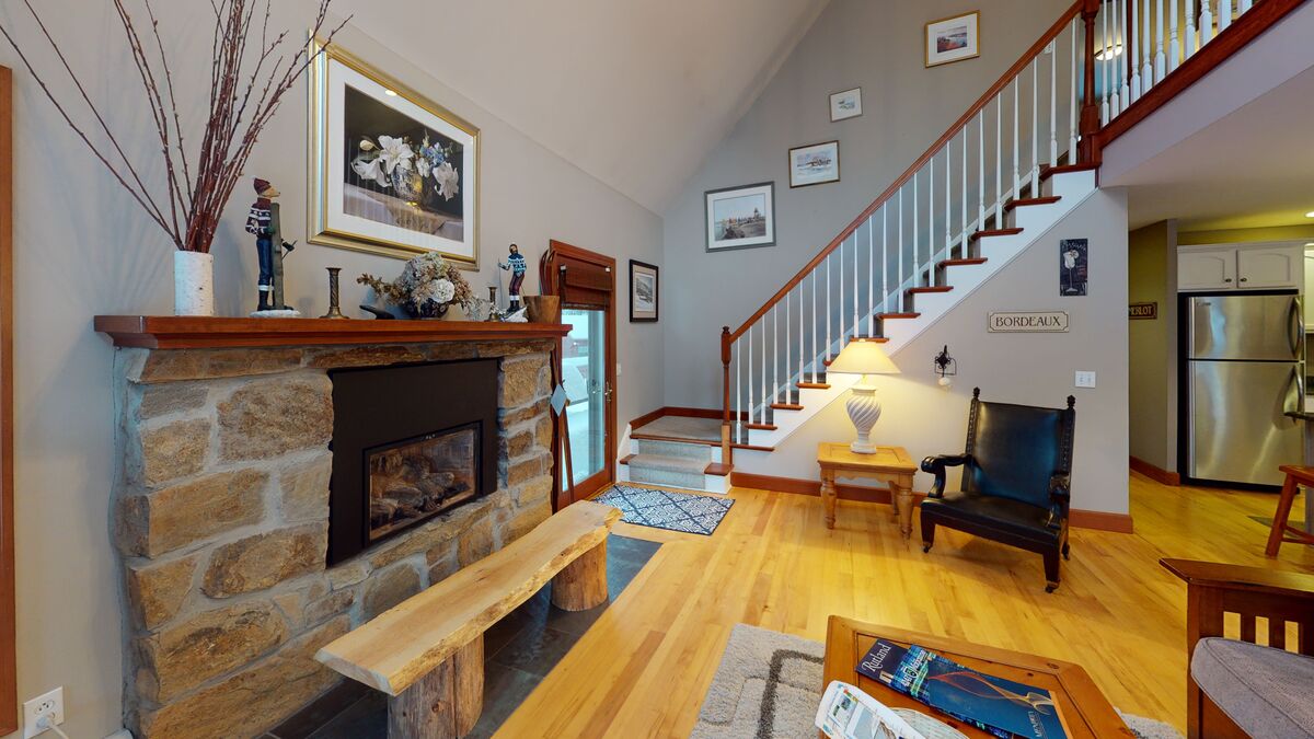 Living Room with Fireplace Next to the Stairs in Our Mendon Vacation Rentals.