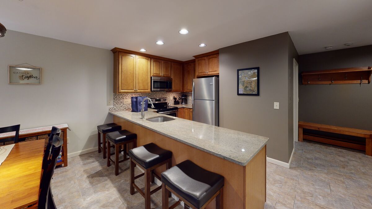Kitchen with Counter Table and Refrigerator of Our Pico Slopeside Vacation Rentals.