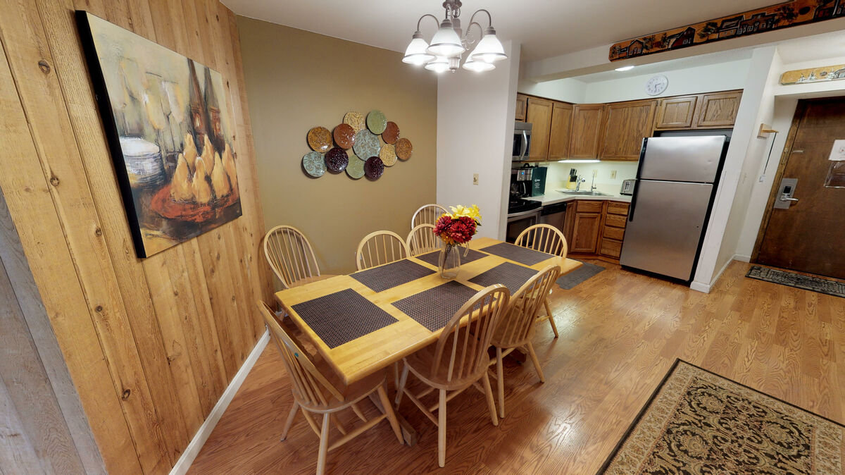 Kitchen with Refrigerator and Dining Set in one of our Apartments for rent Killington VT.