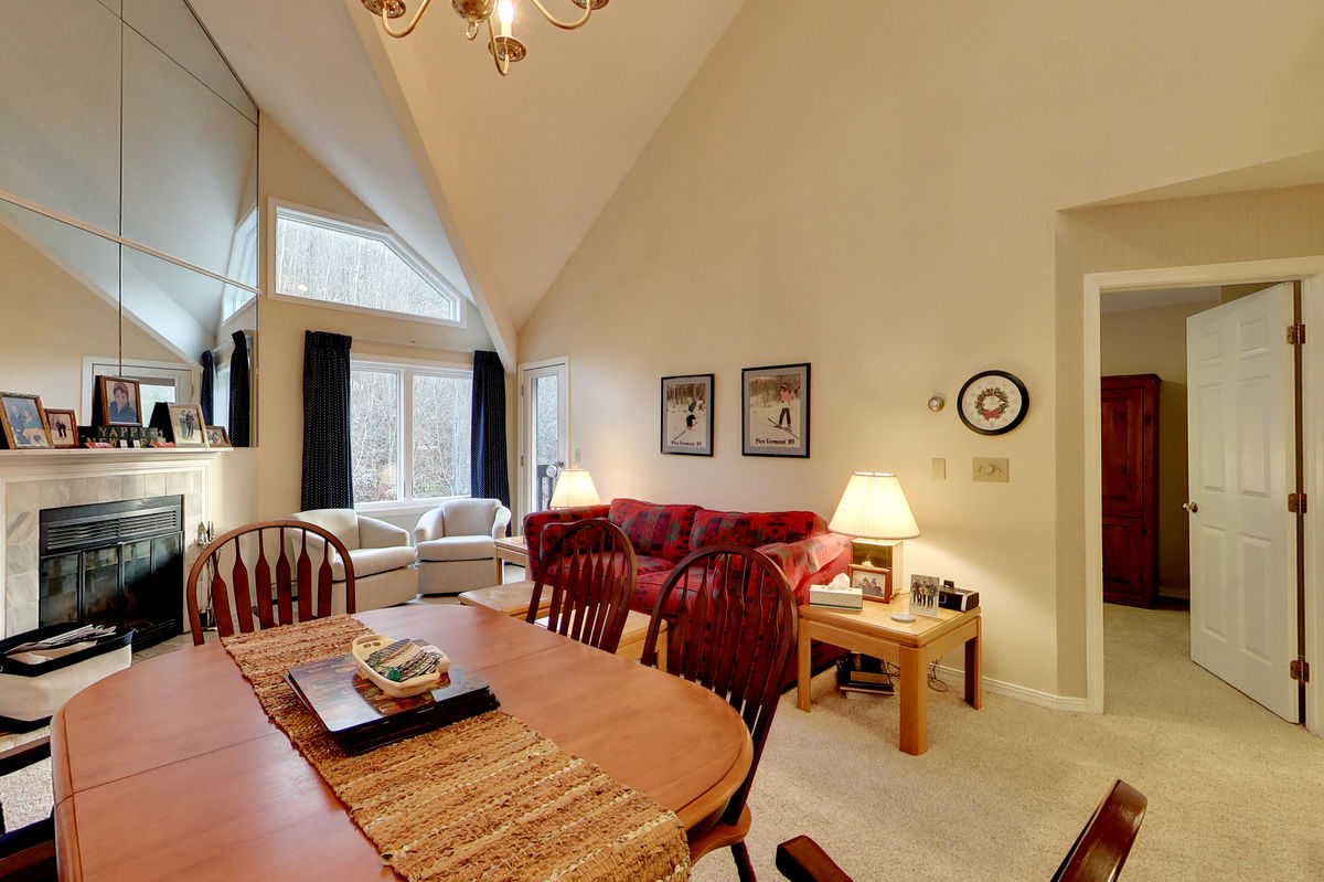 The Dining Space and Living Room with Fireplace of One of Our Family Rentals in Killington.