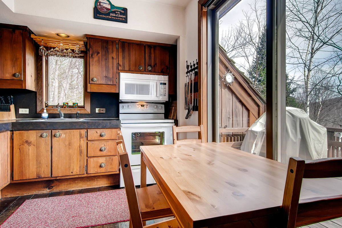 The Kitchen Next to the Balcony with BBQ in One of our Killington Halloween Rentals.