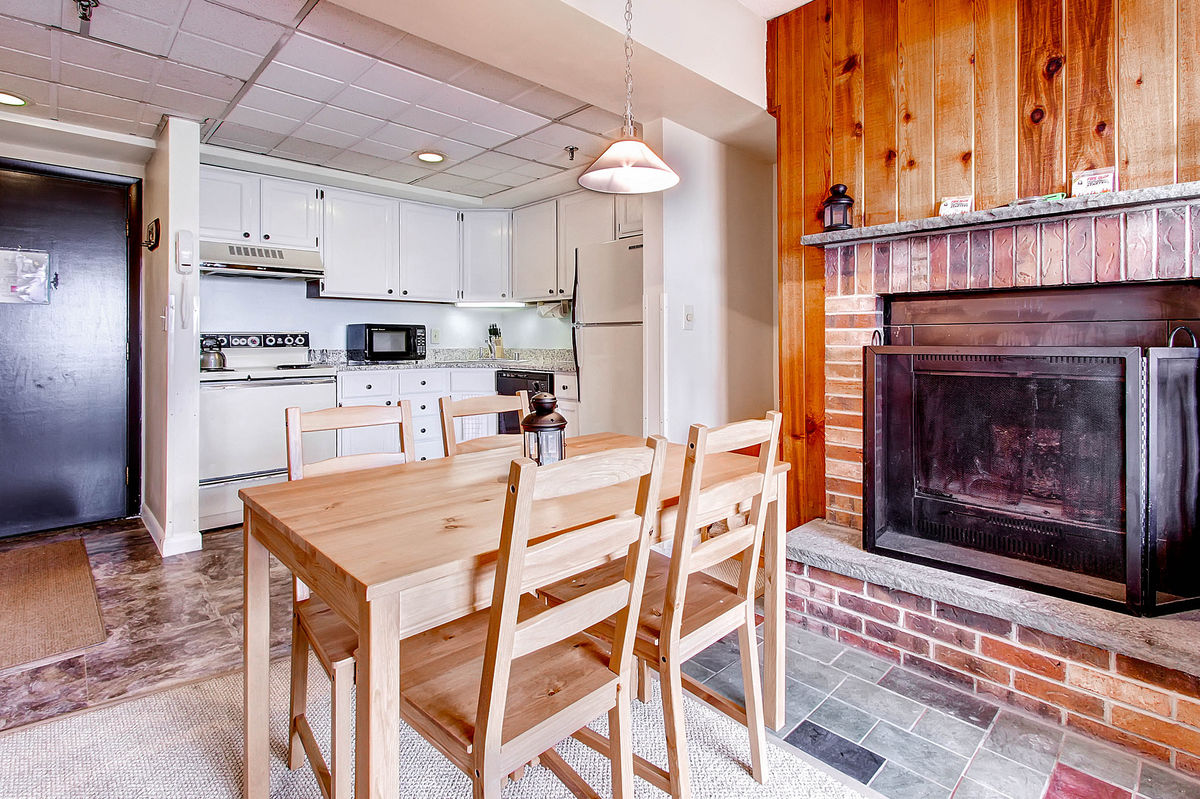 The Kitchen and Dining Space with Fireplace of One of Our Killington Lodging Options.