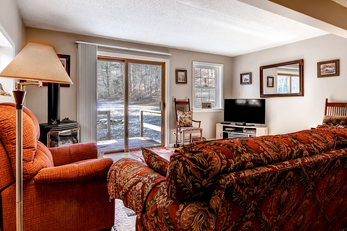 The Living Room with Fireplace and TV of One of Our Killington Seasonal Rentals.