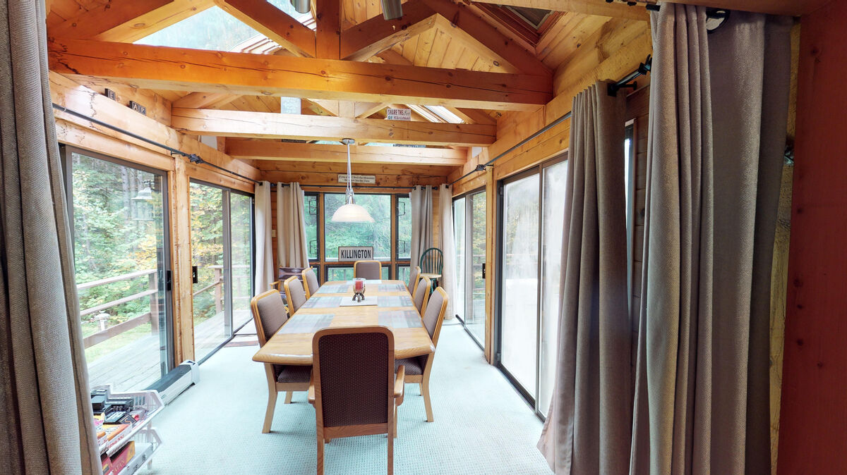 Dining Room Surrounded by Windows Overlooking the Mountains in Our Best Lodging in Killington.